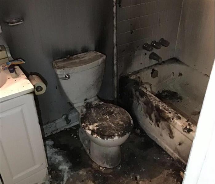 Bathroom covered in smoke and fire damage