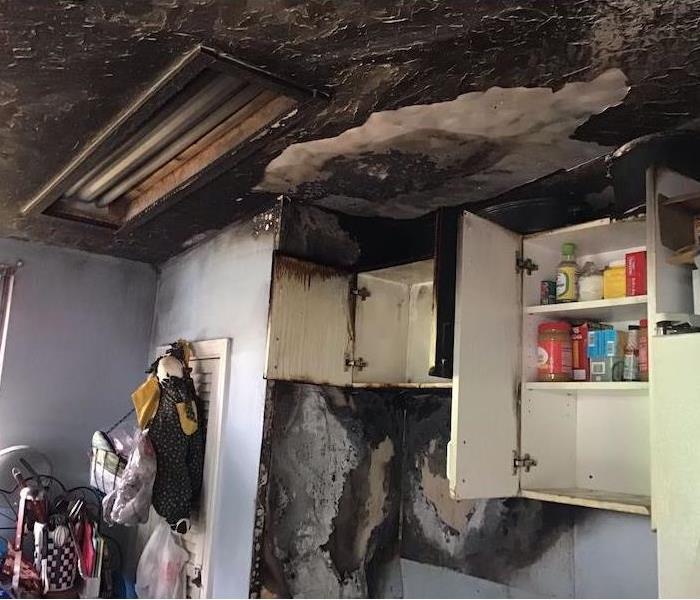 Kitchen ceiling with severe fire and smoke damage
