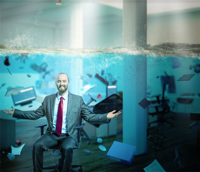 a man sitting underwater in a flooded office