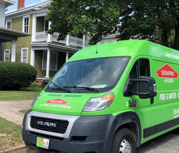 Green SERVPRO van outside of residential home in downtown Augusta